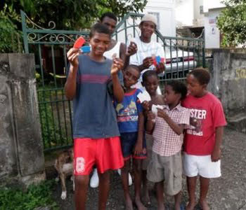 Kids in St Vincent with tracts provided by tellthetriad